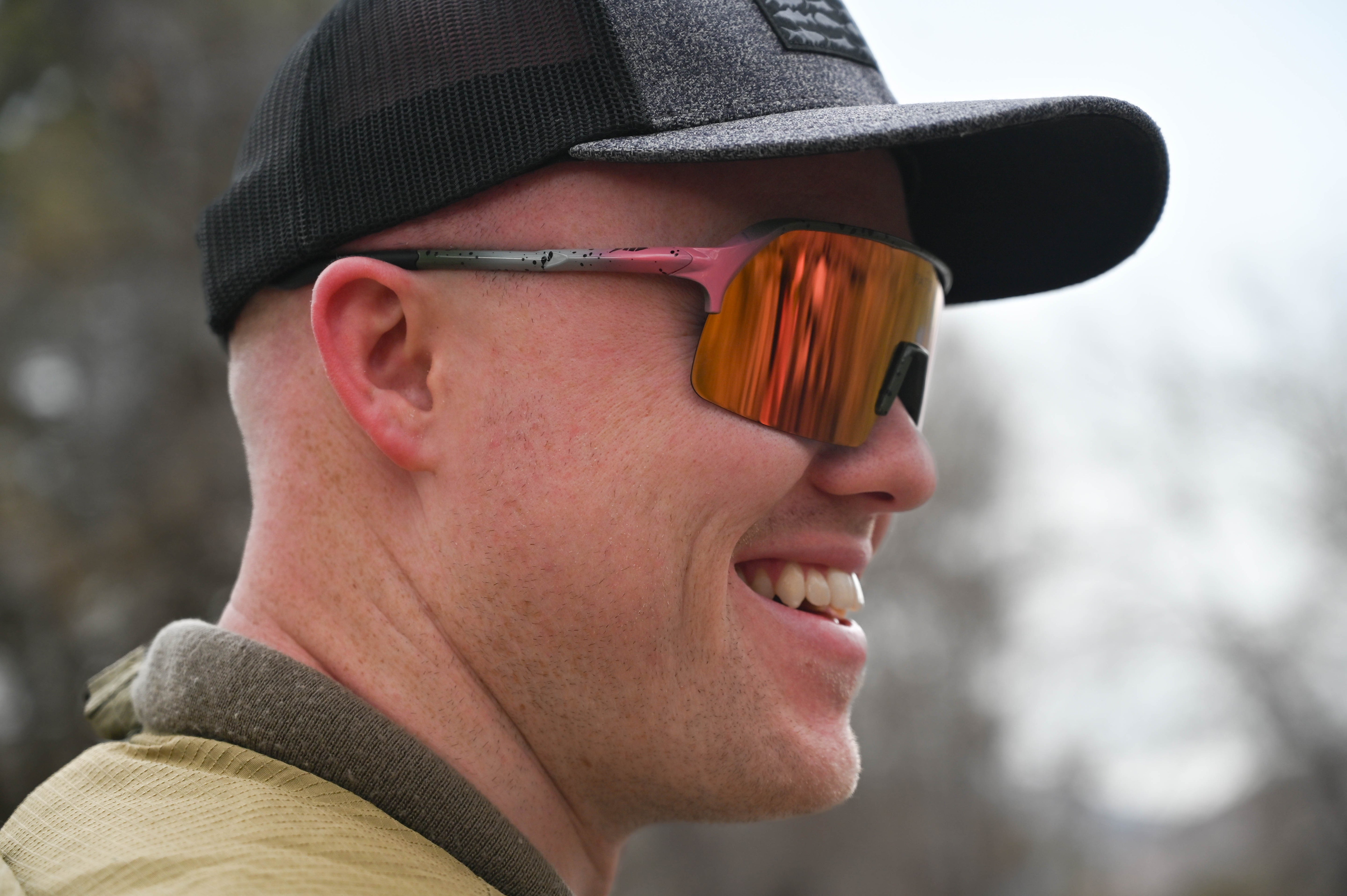 A man wearing a hat and Fats Rainbow Trout sunglasses.